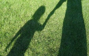 adult_and_child_shadows_on_grass_nr